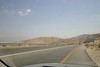 Jonathan Siegel (JSBird) > The sign on the right shows we are at sea level. The Dead Sea is seen faintly at the far left in the distance. The lowest point on earth- 1,300 feet below sea level
