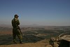Jonathan Siegel (JSBird) > A  soldier on Mt. Bental looks east. In the mid distance the town of Kuneitra, the border now between Syria and Israeli occupied Golan. Damascus is only 40 miles away
