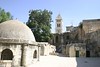 Jonathan Siegel (JSBird) > The Church of the Holy Sepulchre, where Jesus was crucified and buried (briefly). The "modern" church starts from the Byzantine era, and was one of the oddest structures I have ever seen- like a committee put it together over 1500 years. Here, on the roof, one can see remnants of Byzantine wall column supports which means that this "roof" was at some point indoors. The huts belong to the Ethiopian church (see next slide)