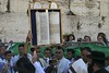 Jonathan Siegel (JSBird) > Multiple Bar Mitzvah ceremonies were taking place. Here the Torah is shown aloft after the reading. The men and women are separated by a fence